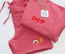 Load image into Gallery viewer, Dusty Pink Crewneck and Matching OG Cropped shorts with initials in Cooper font in red thread, and a rainbow and lightening bolt embroidered on shorts