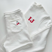 Load image into Gallery viewer, Off White K set with initials embroidered in  Cooper font and a cherry embroidered on back pocket